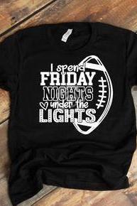 I spend Friday nights under the lights. Friday night lights. Football mama shirt. Football life.Bella Canvas